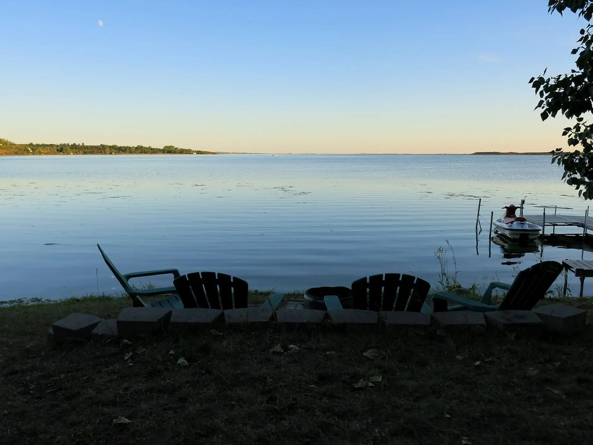 Jackfish Lake at dusk with lawn chairs and dock