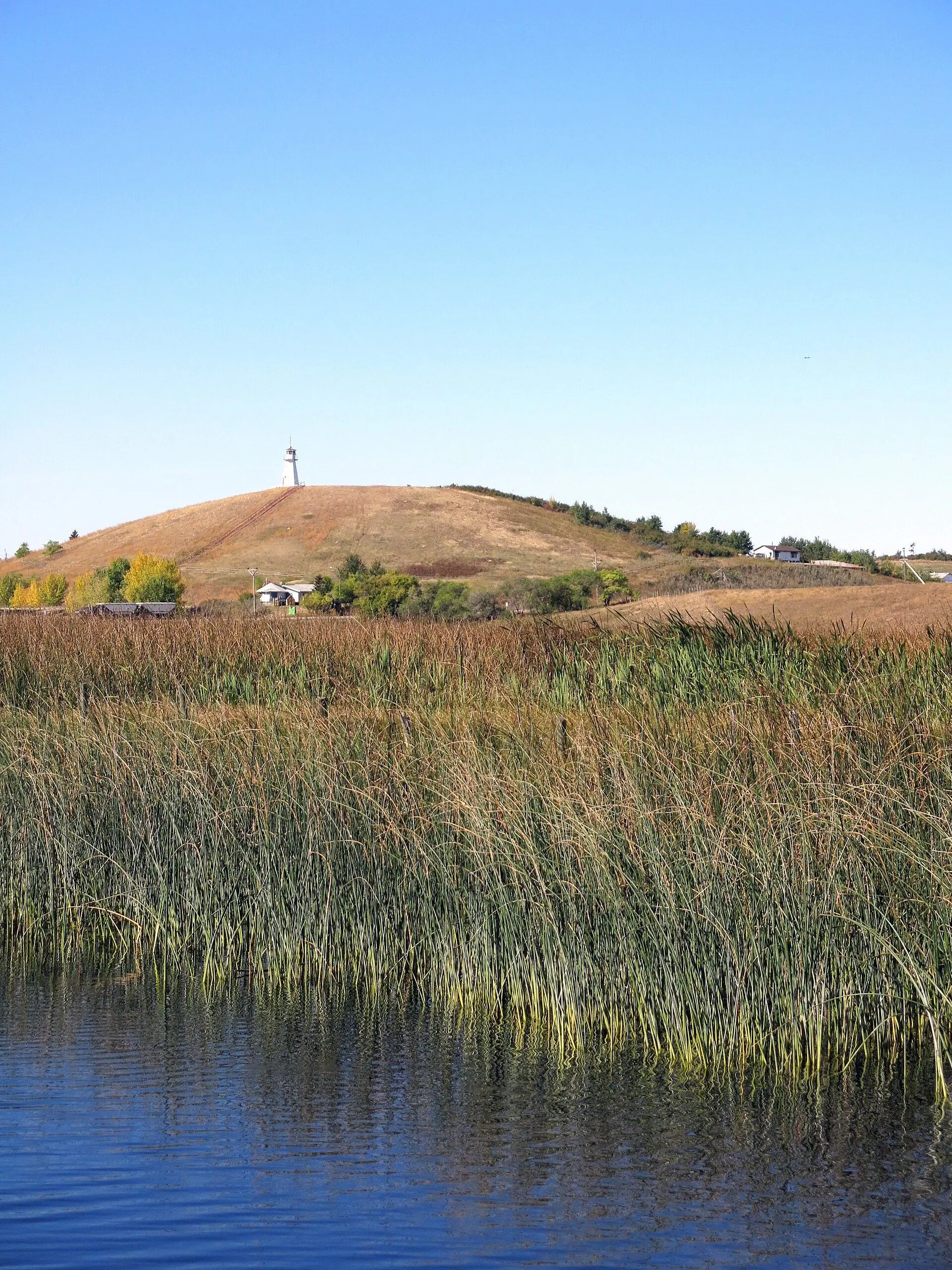 Reeds on Jackfish Lake with hill and lighthouse tower